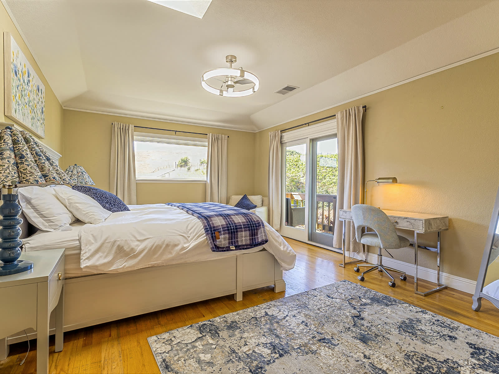 Bedroom four, with a desk and the door to the deck